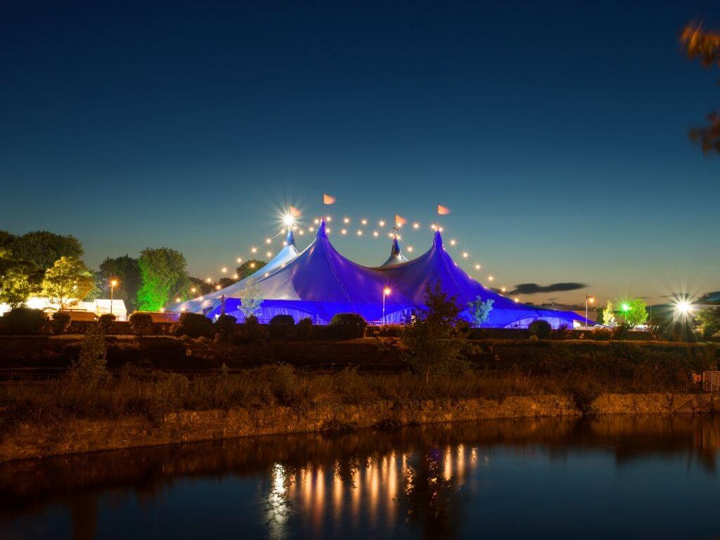 The main tent at the Galway Arts Festival with lights along the big top