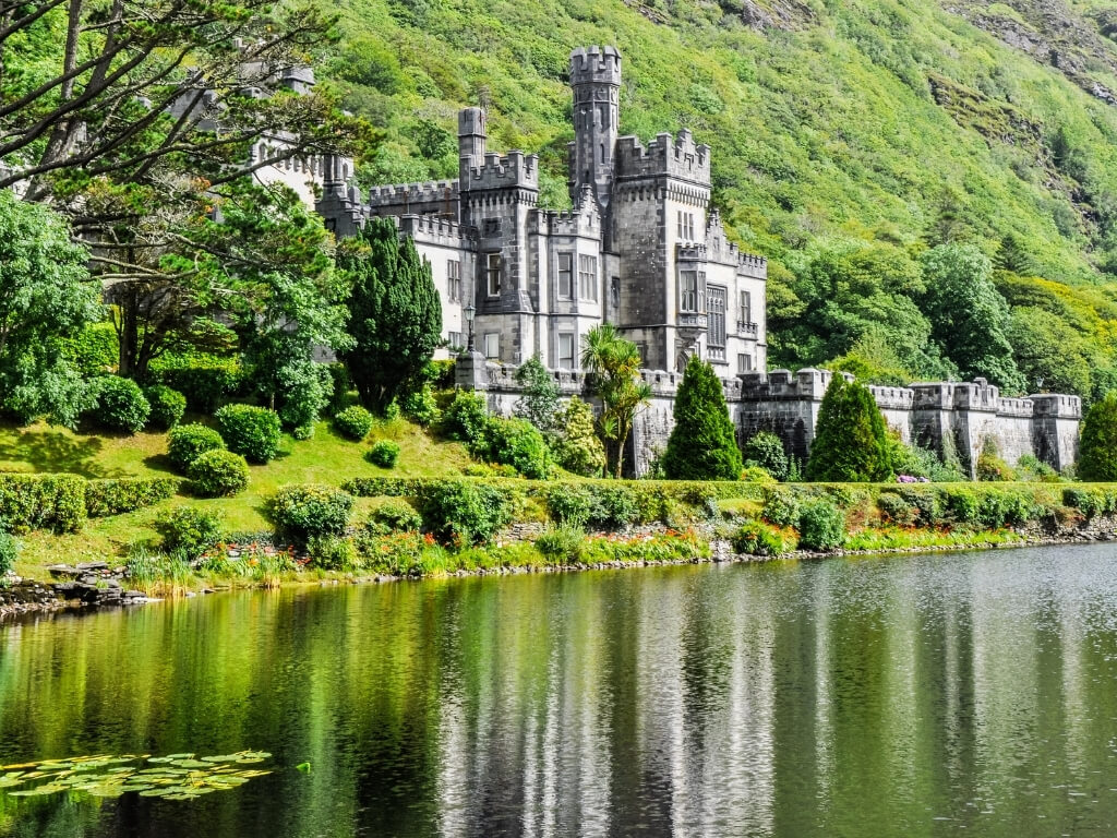 A picture of Kylemore Abbey, nestled on the lush green banks of Lake Kylemore.