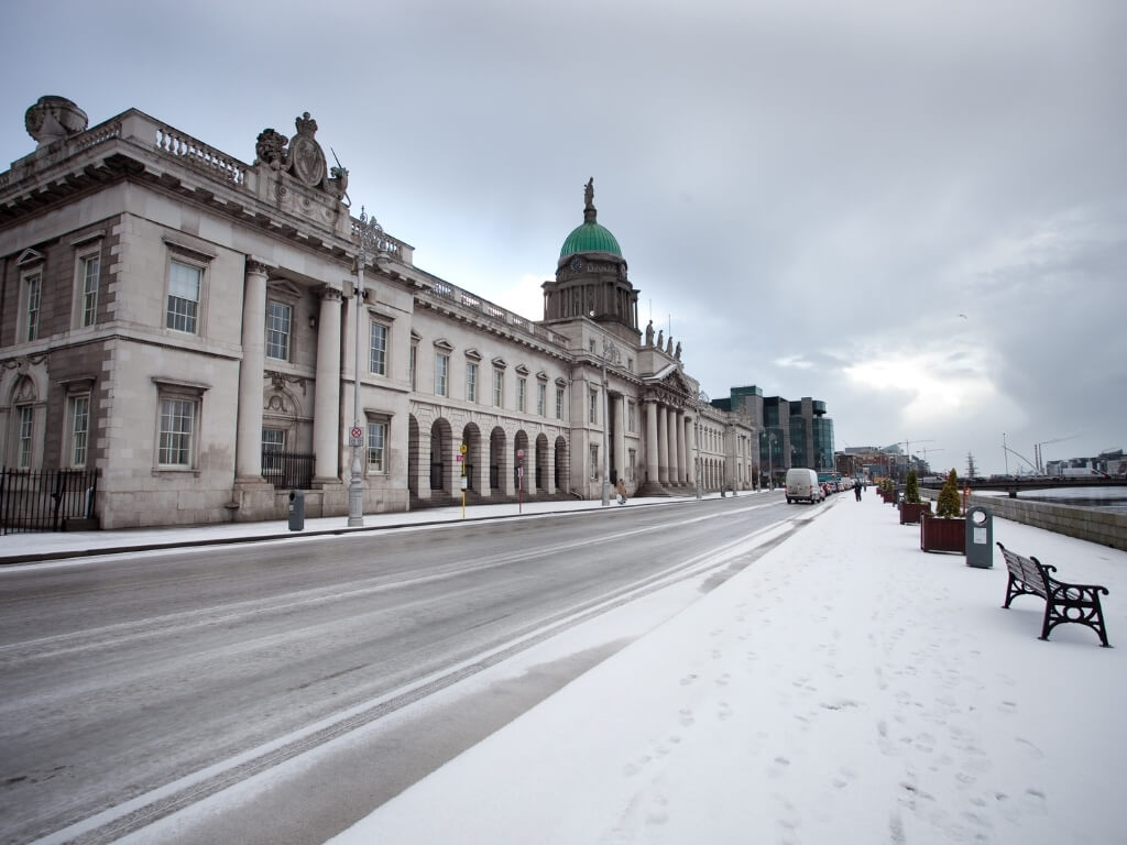 A picture of snow fall outside the Four Courts buildings along the River Liffey in Dublin, Ireland