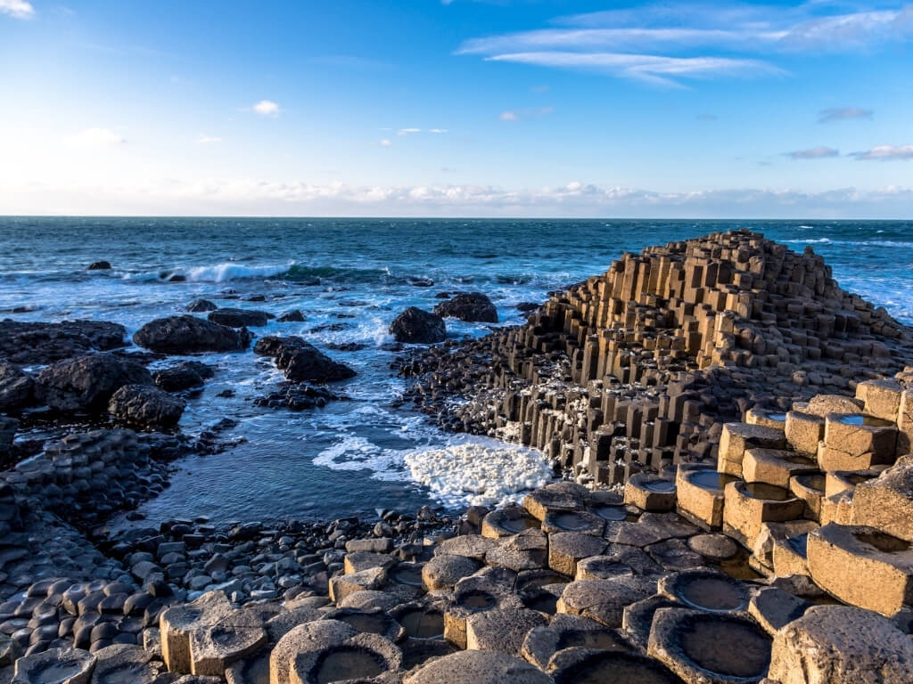 A picture of the Giant's Causeway with blue skies above it