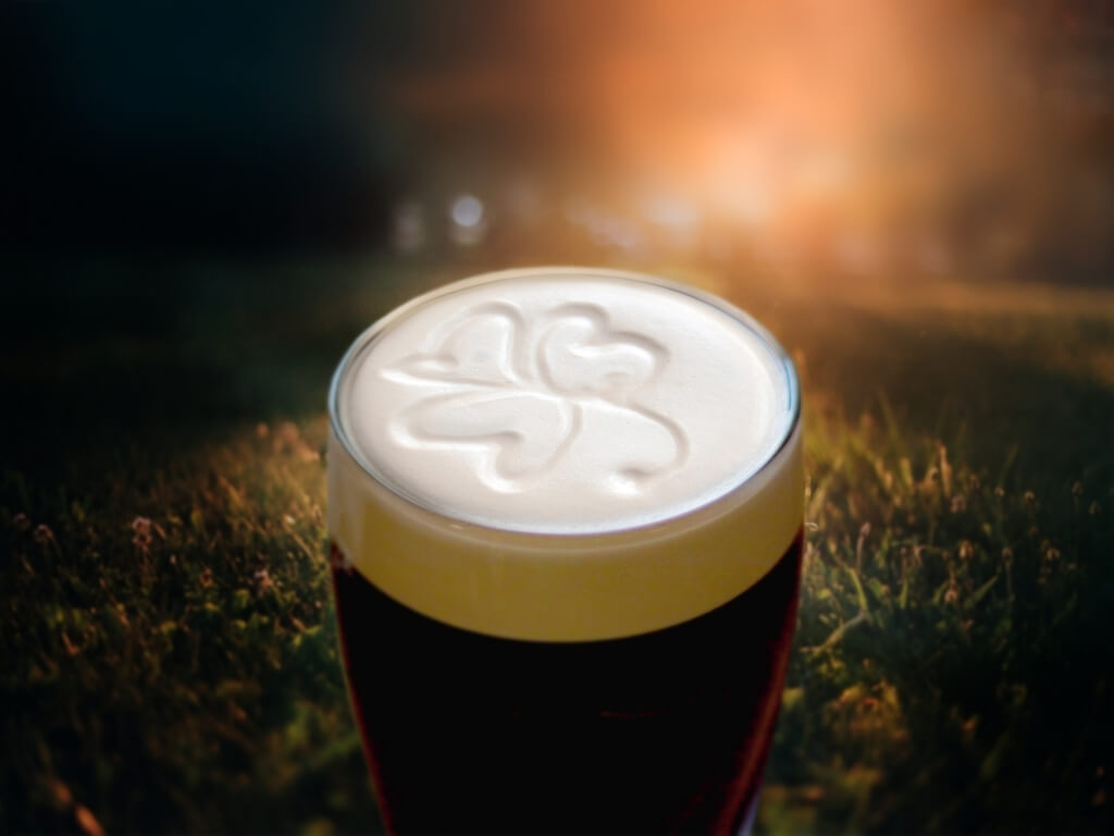 A picture of the head of a pint of Guinness topped with a shamrock