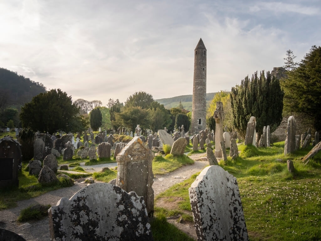 A picture of the round tower and graveyard at the monastic site of Glendalough in County Wicklow, Ireland