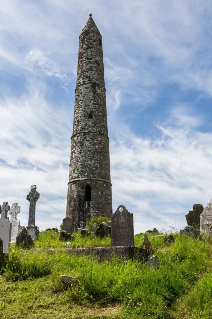 A picture of the round tower at Ardmore surrounded by gravestones