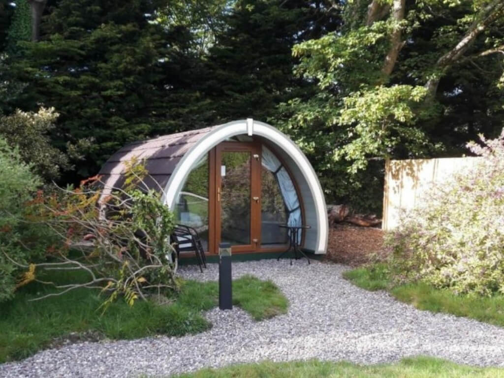 A picture of a glamping pod set among the trees at the Priory Glamping Pods and Guest Accommodation, Kerry