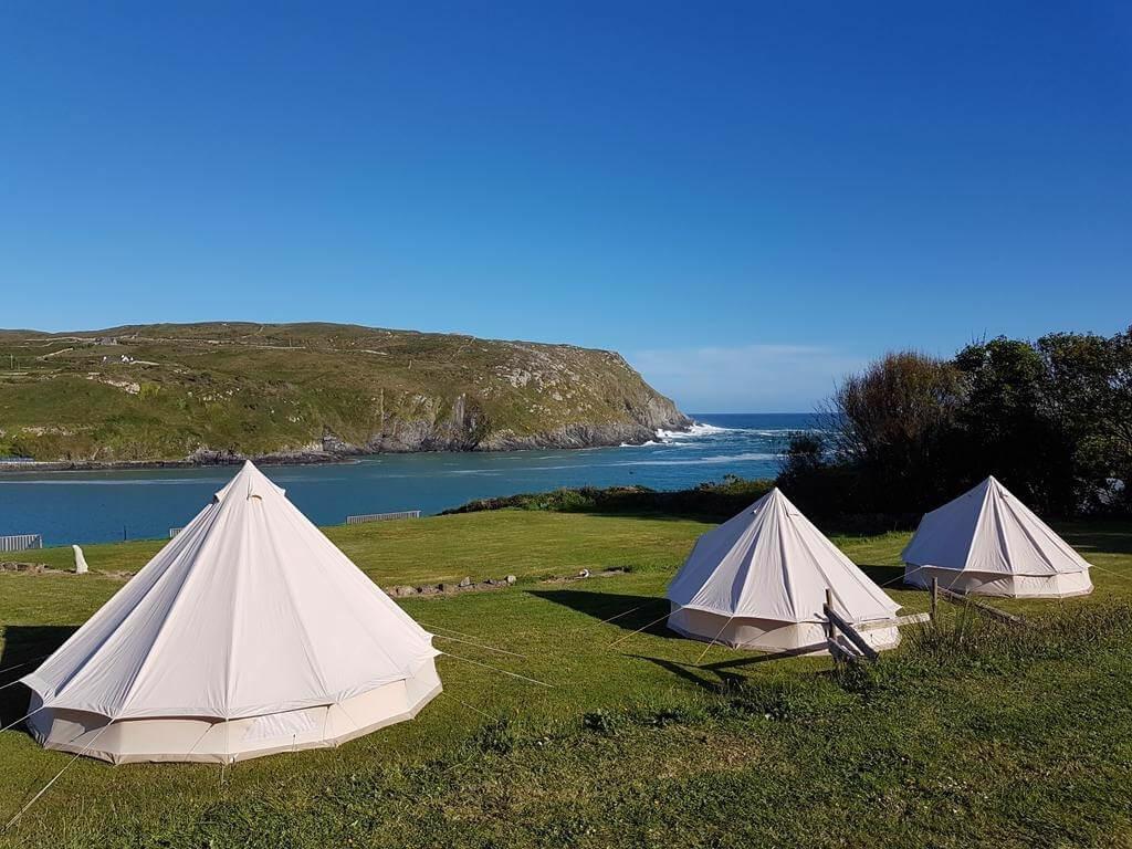 A picture of some of the bell tents of Chleire Haven Glamping overlooking the sea