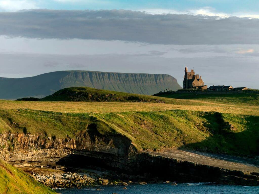 A picture of Sligo landscape with the Classiebawn Castle in the distance and Benbulbin behind it