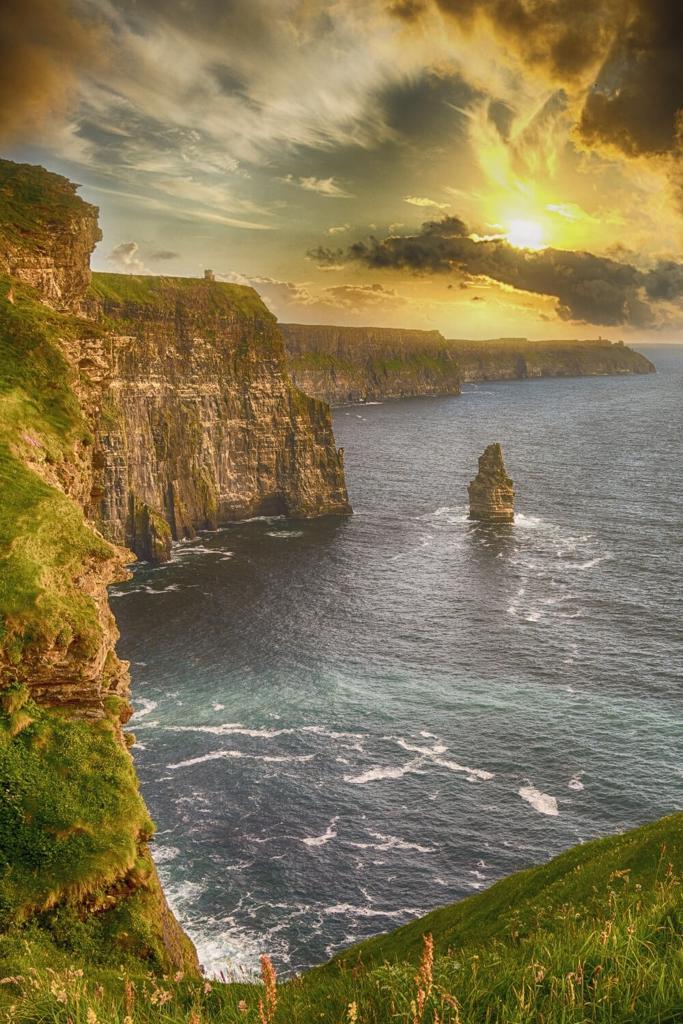 A picture of the sun setting over the Cliffs of Moher that lie along the Wild Atlantic Way, Ireland