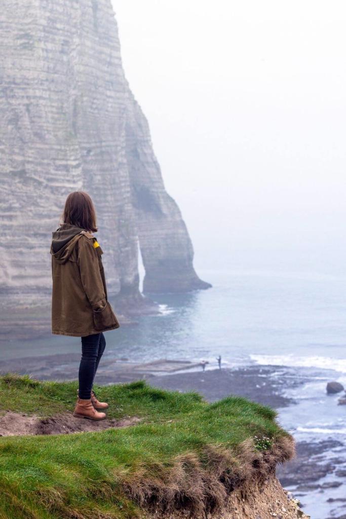 A picture of a woman looking at cliffs along the Irish coast