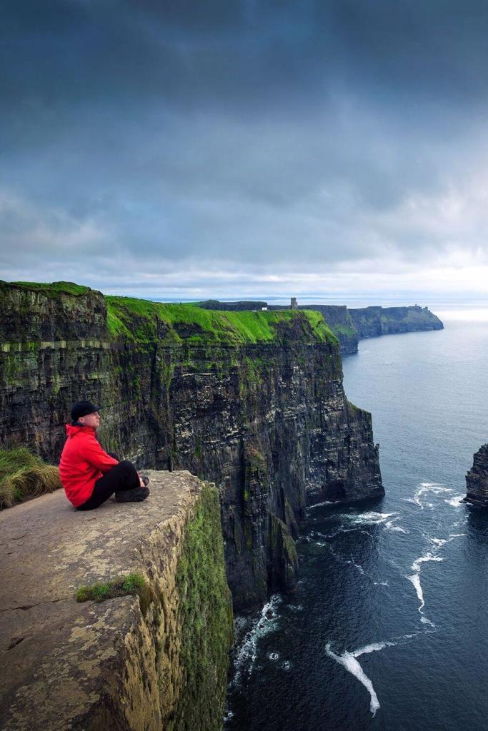 A picture of a man enjoying views of the Cliffs of Moher