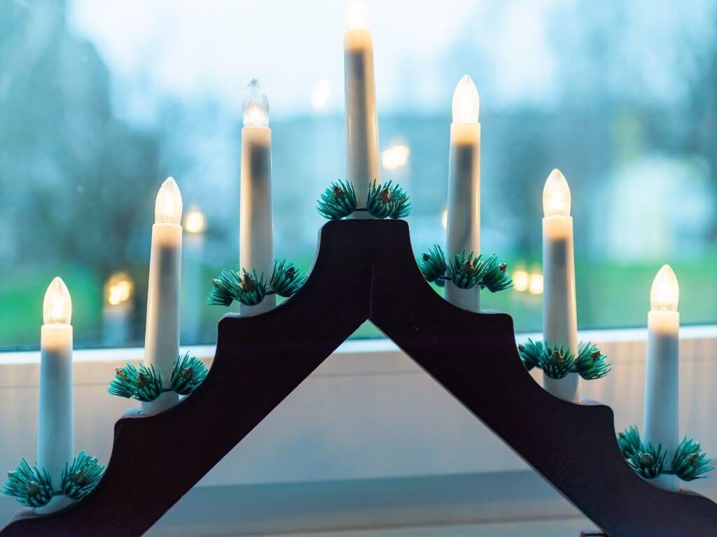 A picture of a traditional Christmas Candle in the Window with 7 electronic candles