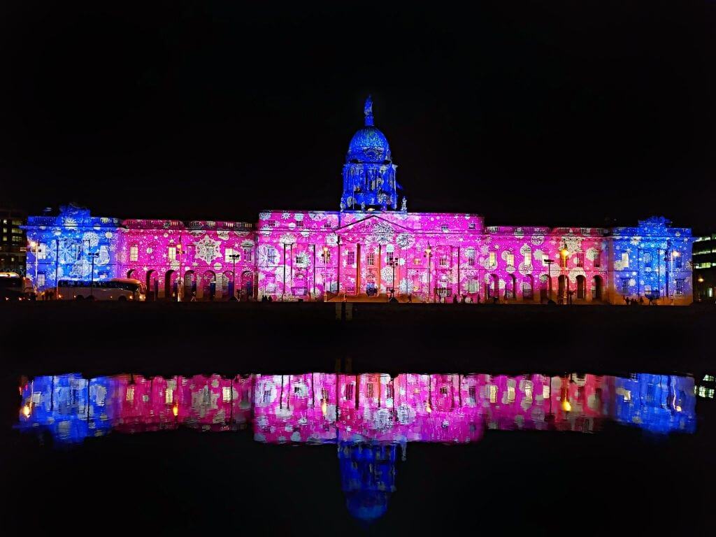 A picture of Dublin's Custom House at Christmas lit up by lights