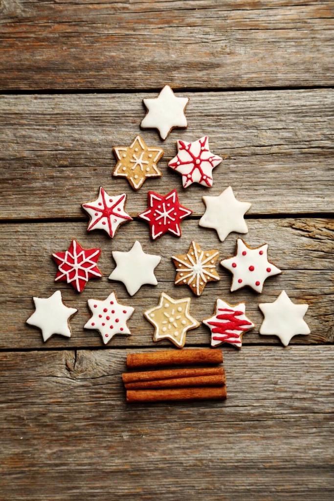 A picture of some star Christmas biscuits arranged in the shape of a Christmas tree