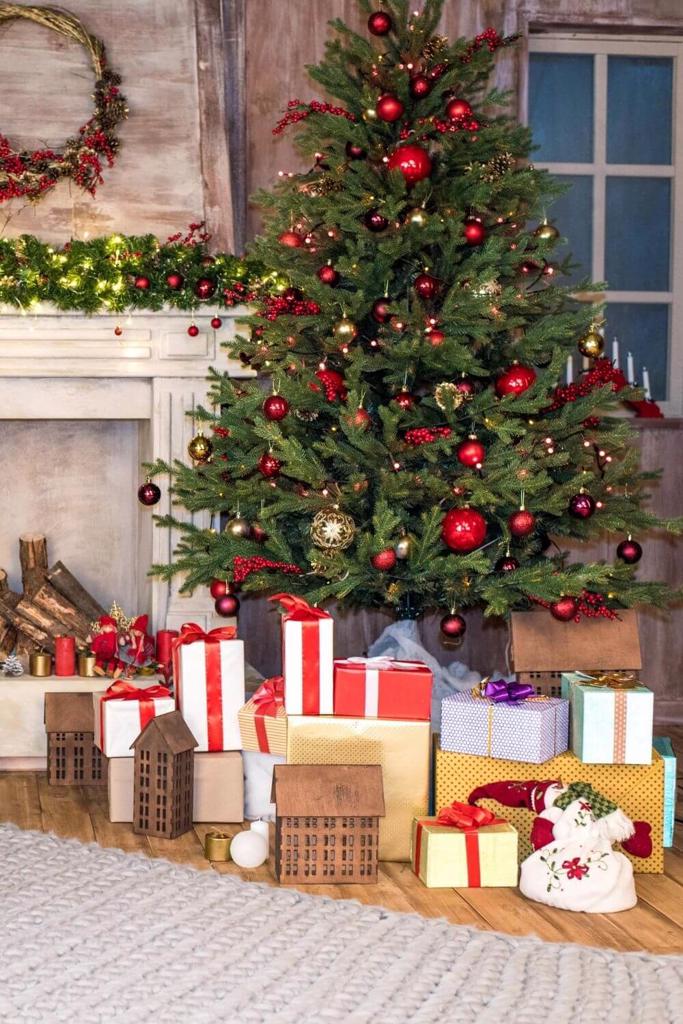 A picture of a Christmas tree with presents underneath it