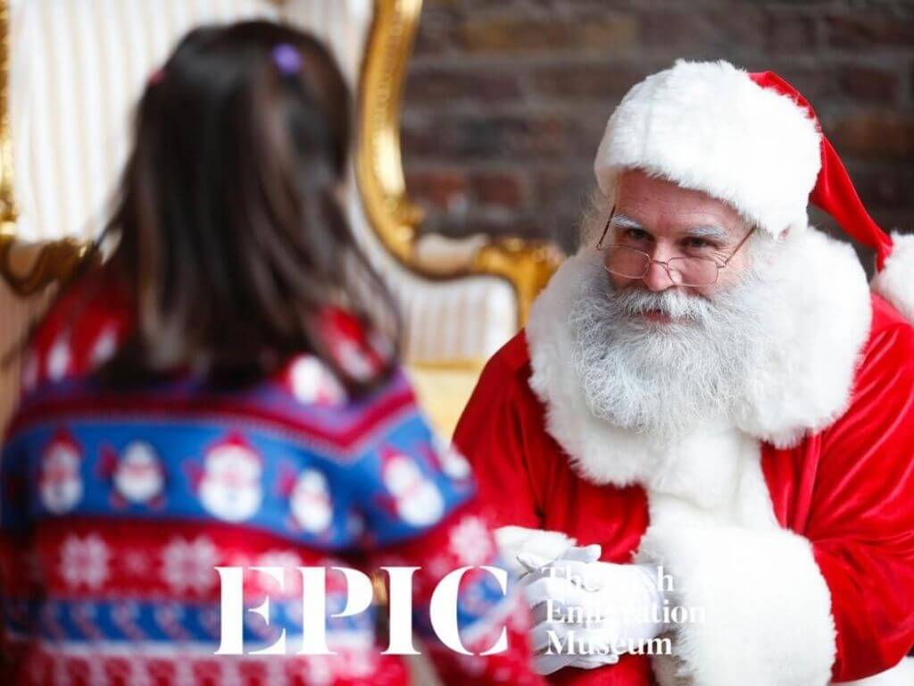 A picture of a Santa greeting a girl in the advertisement for EPIC Museum Christmas