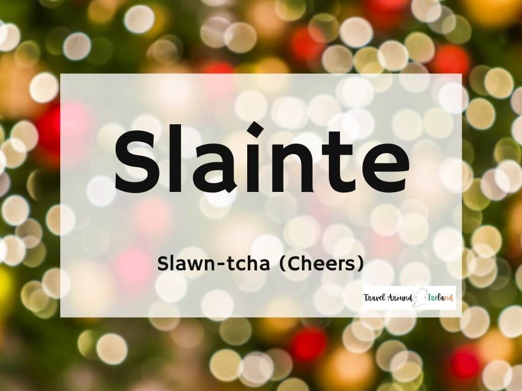 A picture with text over bokeh lights saying Slainte meaning Cheers in Irish