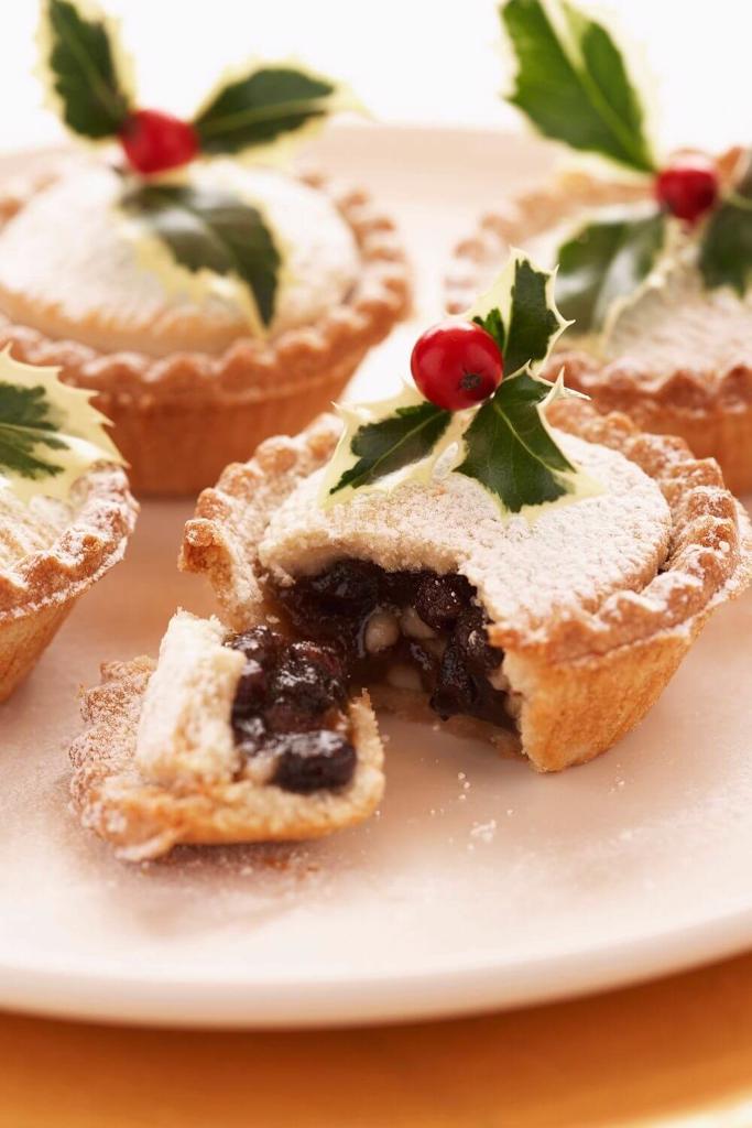 A picture of some festive mince pies decorated with springs of holly