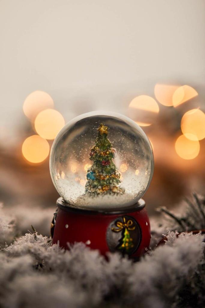 A picture of a Christmas tree in a snowglobe