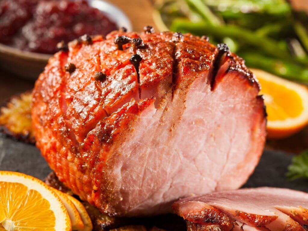 A picture of a carve piece of Honey Glazed Ham with Cloves
