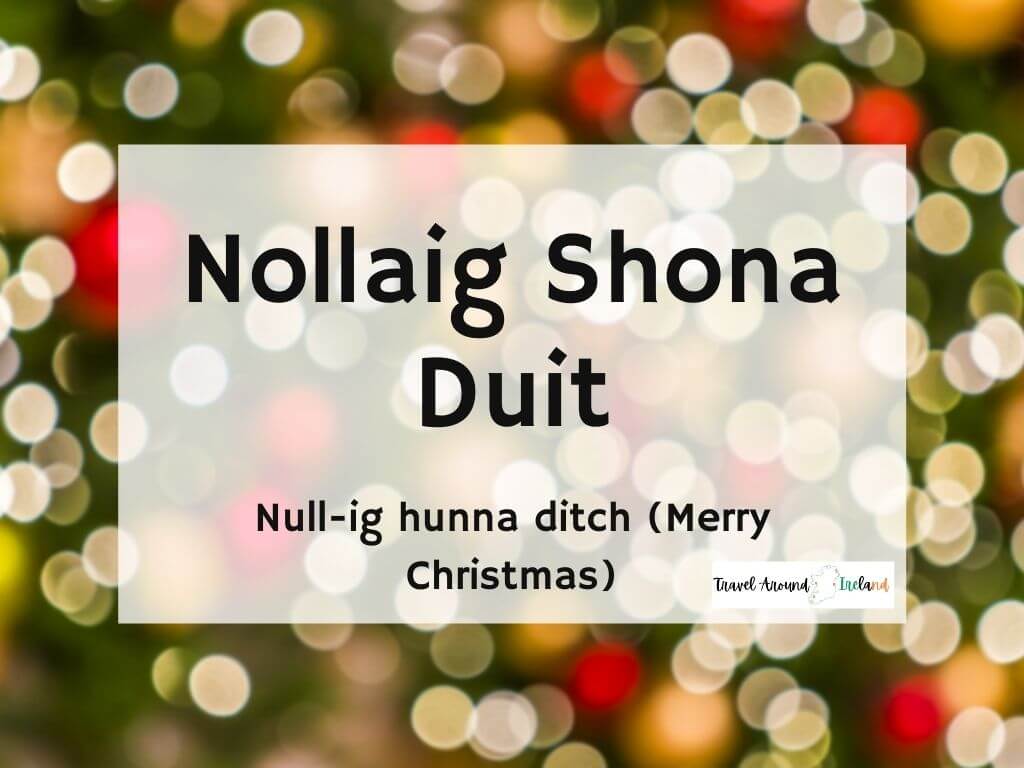 A picture with text over bokeh lights saying Nollaig Shona Duit meaning Merry Christmas in Irish