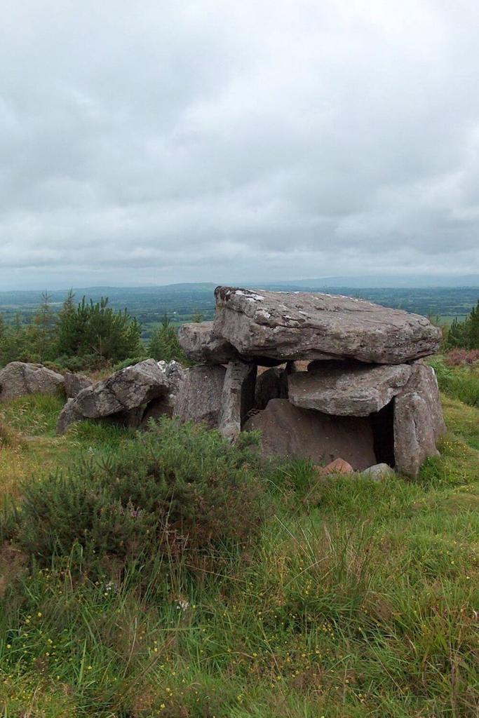 A picture of the Duntryleague Passage Tomb, County Limerick with cloudy skies overhead