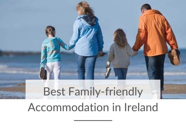 A picture of a family of four, walking on a beach in Ireland, with text overlay saying Best Family-friendly Accommodation in Ireland