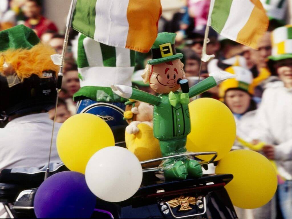 A leprechaun balloon on top of a bike taking part in the St Patrick's Day Parade, Dublin