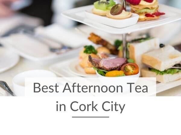 A table set for afternoon tea with a double white tiered tray set and text overlay saying best afternoon tea in Cork City