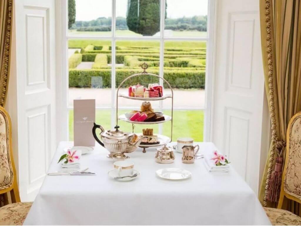 A beautifully laid talbe ready for the Castlemartyr Resort afternoon tea with three tiers of treats and pot of tea
