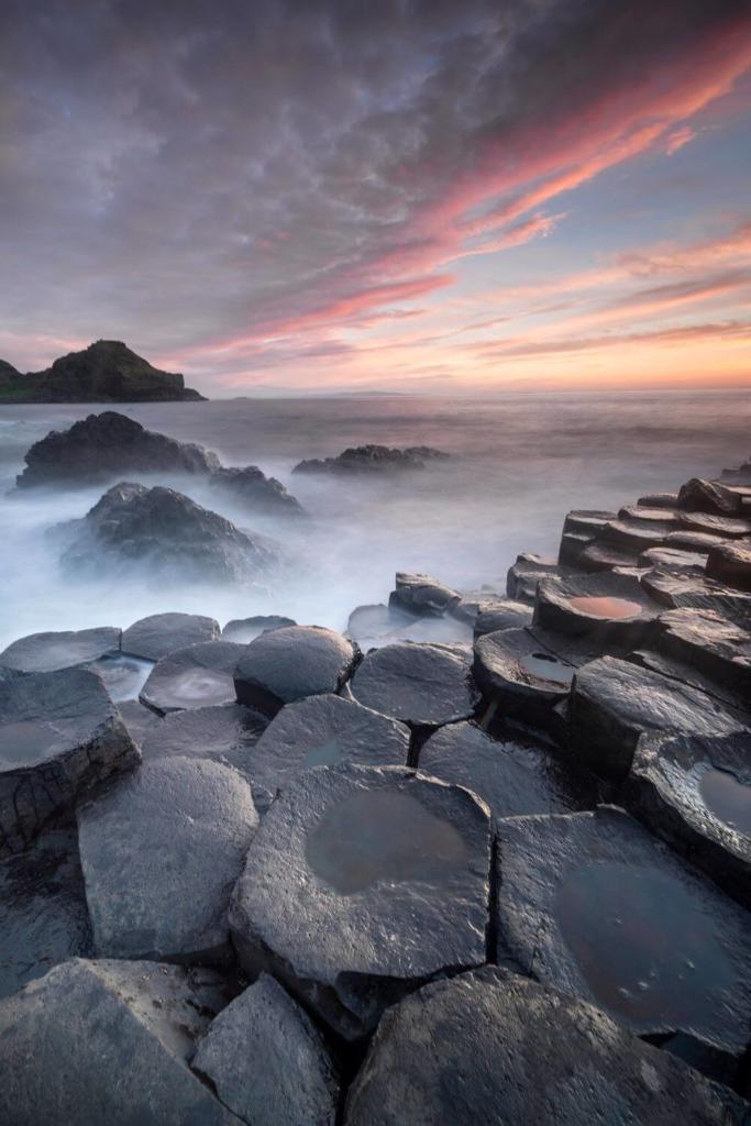 A picture of sea fog drifting over the hexagonal rocks of the Giants Causeway in County Antrim Northern Ireland