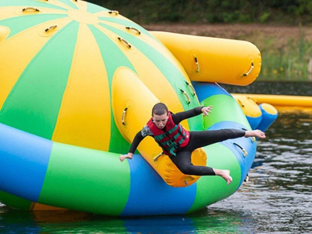A picture of a boy falling off an inflatable at The Lake Kilrea