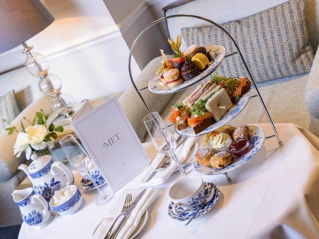 A picture of a three-tiered tray on a table ready for The Metropole Hotel afternoon tea