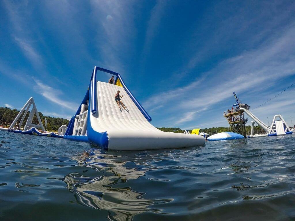 A picture of someone coming down one of the inflatable slides at West Coast Aqua Park