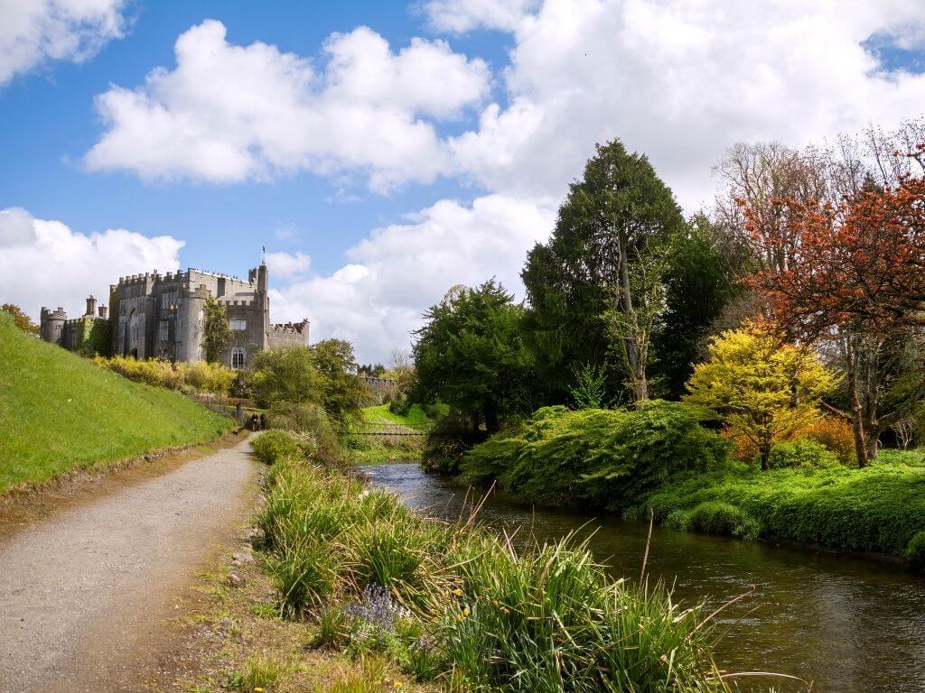 A picture of the river and a path beside it with Birr Castle, County Offaly in the background