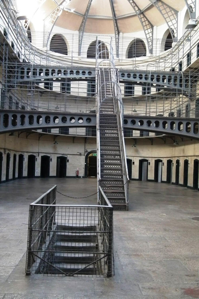 A picture of the iconic staircase inside Kilmainham Gaol in Dublin, Ireland , one of the best historical landmarks in Ireland