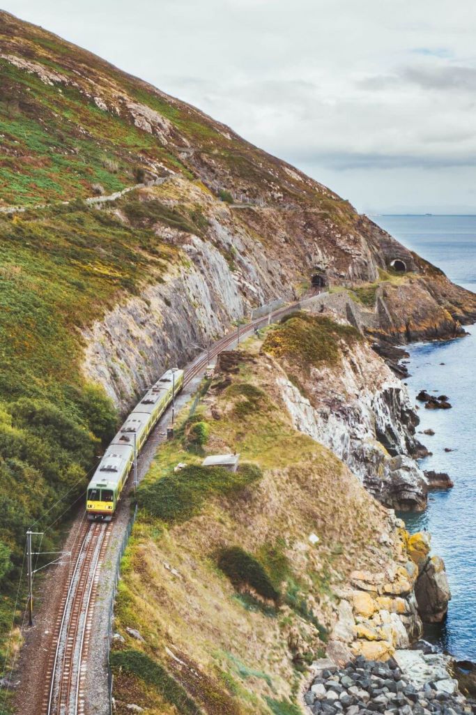A picture of a DART train running along the coast on a section of the line between Bray and Greystones