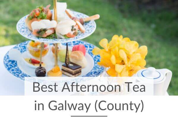 A two-tiered cake stand with food and a teapot on a table with text overlay saying best afternoon tea in Galway (County)