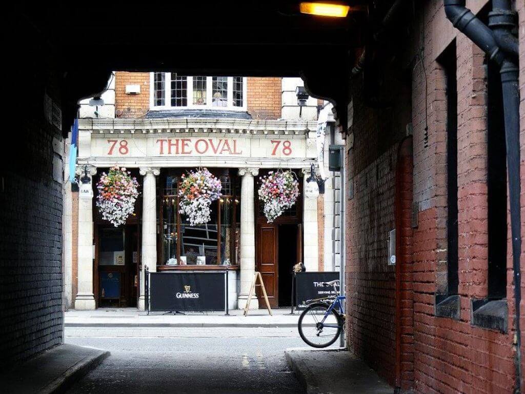 A picture looking at The Oval pub, Dublin, Ireland through a laneway