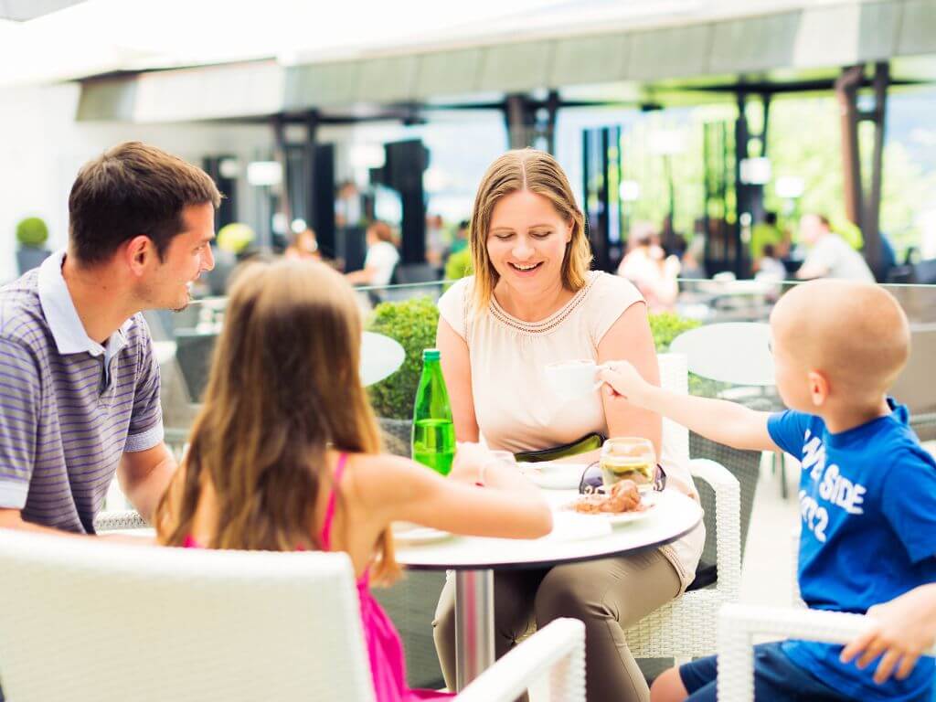 A family of four having a meal at a light and airy restaurant