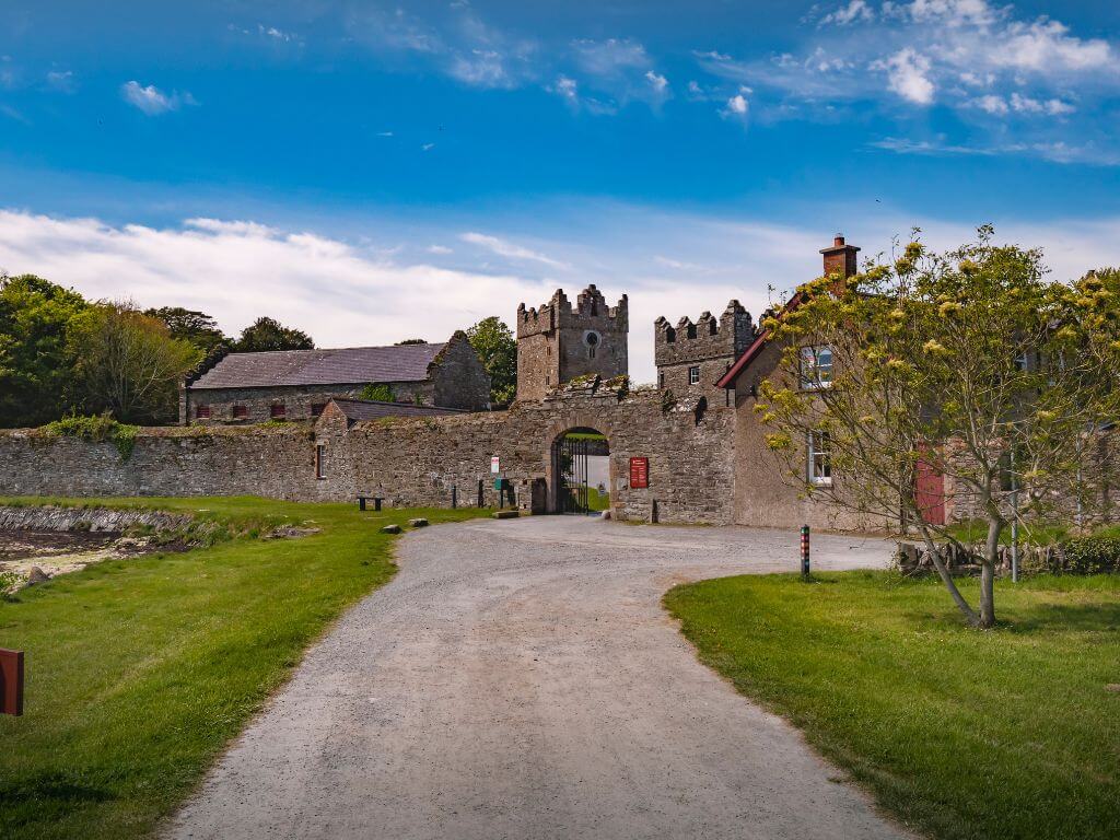 A picture of the entrance and castle walls of Castle Ward, Northern Ireland, one of the Game of Thrones filming locations in Northern Ireland