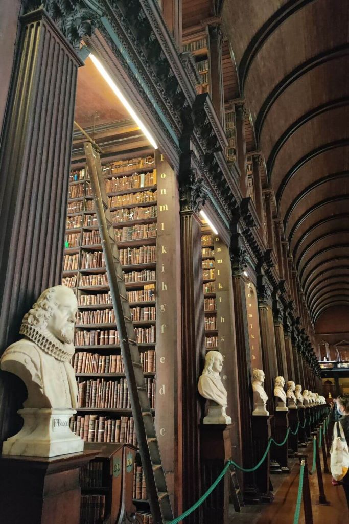 A picture of the busts and library shelves of the Trinity College Long Room