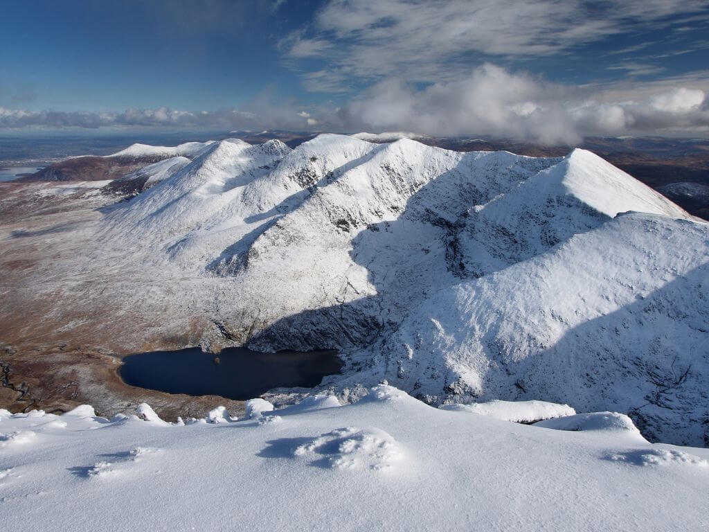 A picture of Carrauntoohil during winter covered with snow