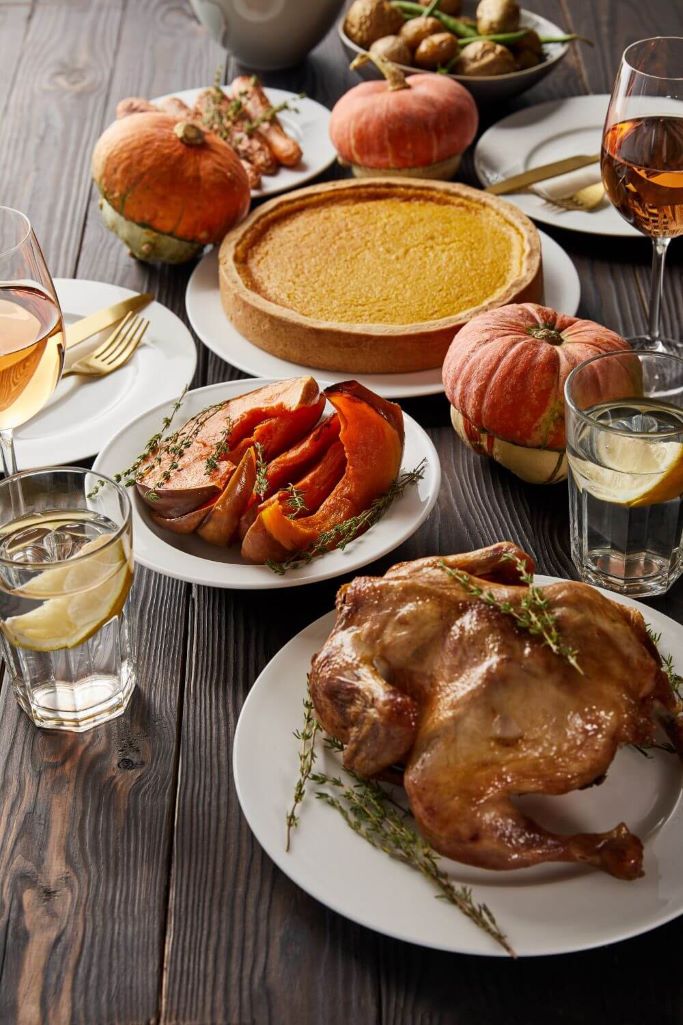 A picture of a Thanksgiving dinner laid out on a wooden table
