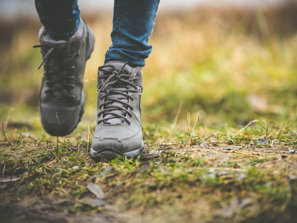 A picture of someone in hiking boots showing the feet and ankles only