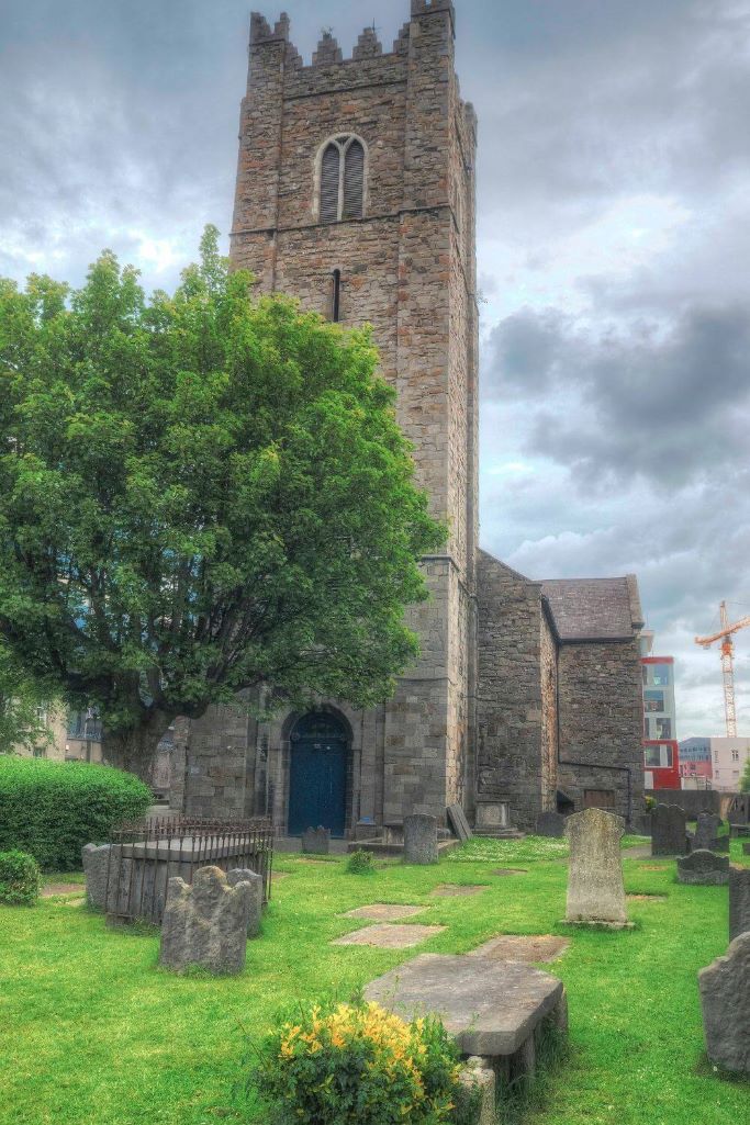 A picture of St Michan's Church, Dublin with the graveyard in front of the church