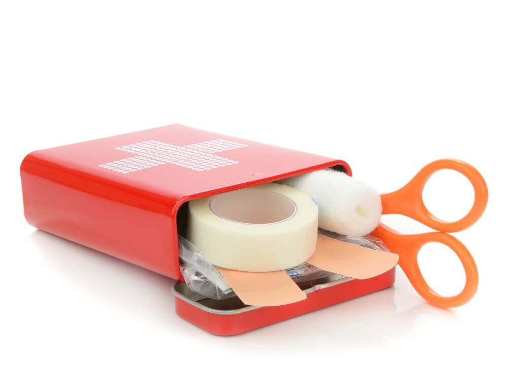 A picture of a small travel first aid kit in a tin