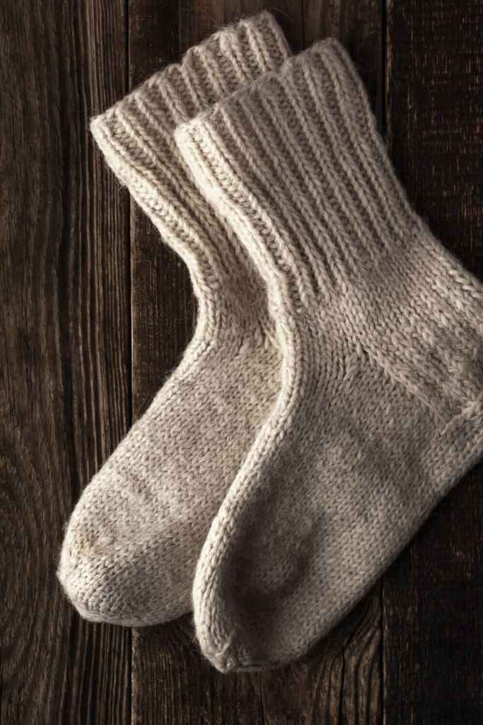 A picture of woollen socks on a wooden floor