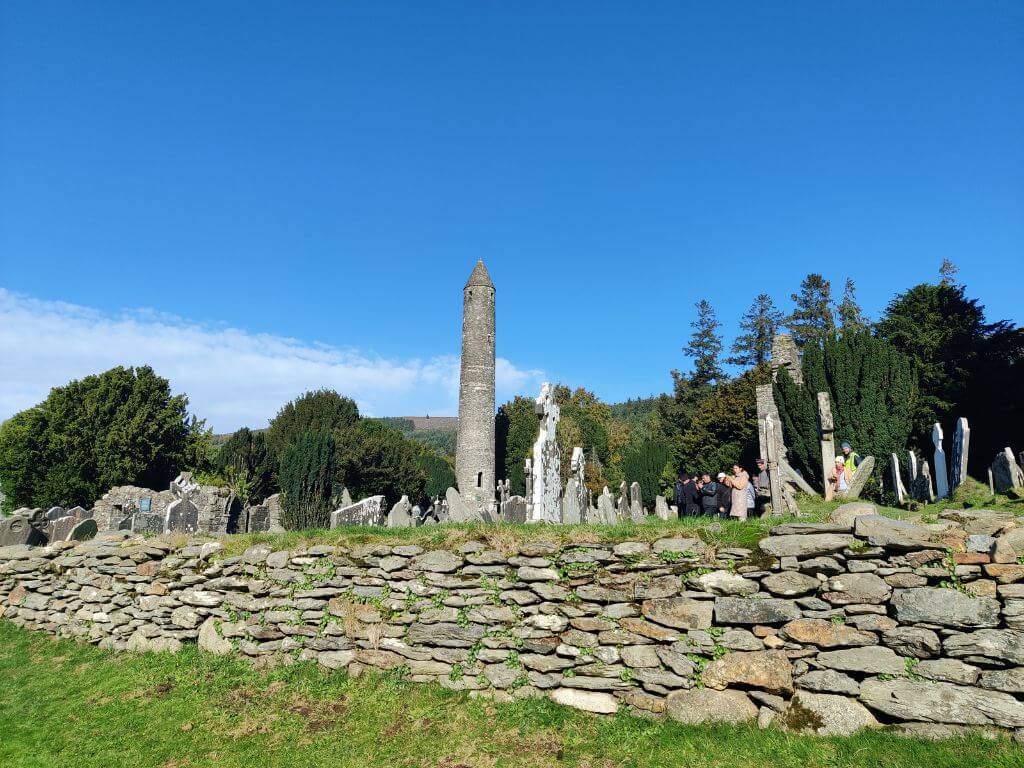 A picture of the monastic site at Glendalough, County Wicklow with blue skies overhead