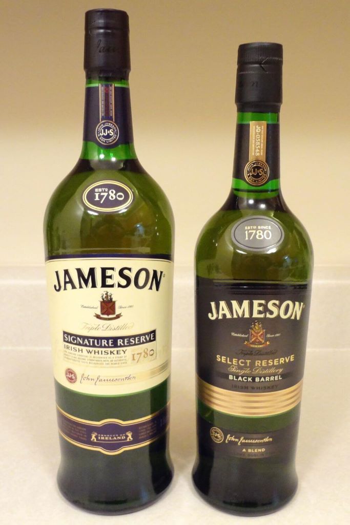 A picture of two bottles of Jameson Irish Whiskey standing side by side with a neutral background