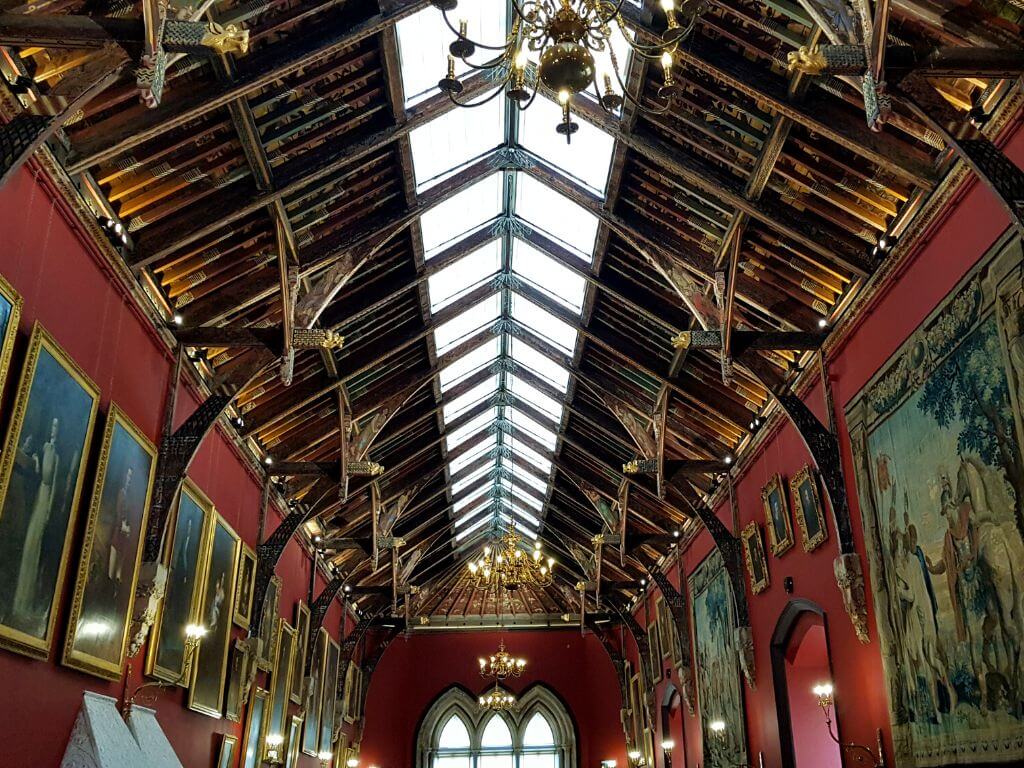 A picture of the roof and upper half of the red walls displays pictures in the Picture Gallery, Kilkenny Castle, Ireland