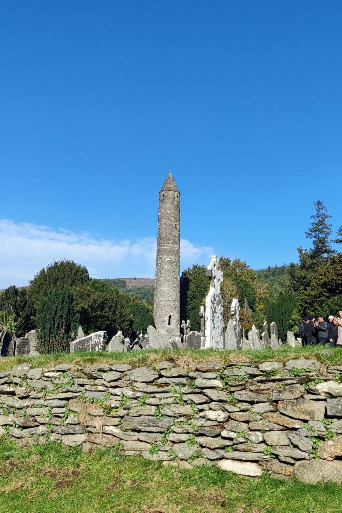 A picture of the round tower from across the graveyard at Glendalough in County Wicklow